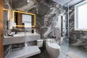 a bathroom with a sink and a toilet and a mirror at Nghia Lan Maison - DL Center in Da Lat +40 photos