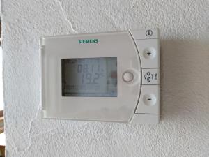 a lightswitch on a wall with a clock on it at Family-friendly apartement in Lumbrein +34 photos