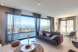 a living room with a couch and a large window at Villa Bella Vista 2 in Ičići +15 photos
