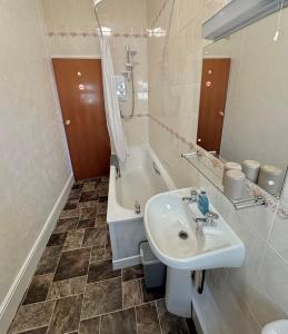 a bathroom with a sink and a bath tub at Ocean View in Ilfracombe +11 photos