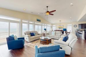 a living room with couches and a ceiling fan at NTB106 Scotch Bonnet Sunrise in North Topsail Beach