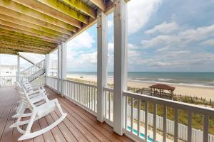 a porch with two chairs and a view of the beach at NTB106 Scotch Bonnet Sunrise in North Topsail Beach