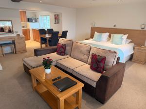 a living room with a bed and a couch at Porthole Suites in Saint Aubin +111 photos