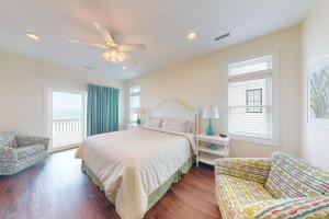 a bedroom with a bed and a ceiling fan at NTB106 Scotch Bonnet Sunrise in North Topsail Beach