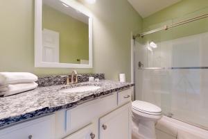 a bathroom with a sink and a shower and a toilet at NTB106 Scotch Bonnet Sunrise in North Topsail Beach +32 photos