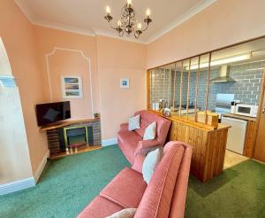 a living room with a couch and a tv at Ocean View in Ilfracombe