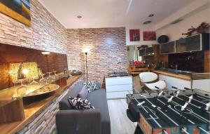 a large living room with a brick wall at PALMIE Gold in Palm Beach +70 photos