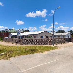a street sign in front of a building at Oloks Guest Inn in Francistown