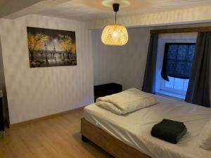 a bedroom with a bed and a picture on the wall at Le Cat'saisons in Wellin