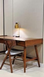 a wooden desk with a lamp on top of it at AINOSAH Residences in Medina +5 photos