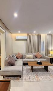 a living room with a couch and a table at AINOSAH Residences in Medina