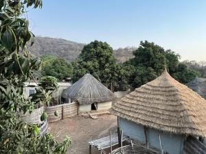 two huts with thatched roofs in a village at Ibel dans le pays Bassaris in Kédougou
