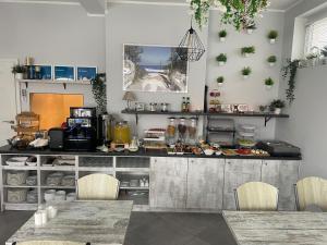 a kitchen with a counter and chairs in a room at Willa Atlantis in Mielno