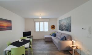 a living room with a couch and a desk at Myhouse Apartment in Cervignano del Friuli