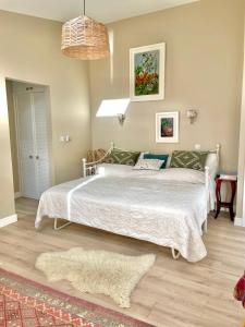 a bedroom with a large white bed in a room at Garden House Barmeath Castle in Grangebellew