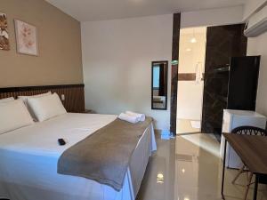 a hotel room with a bed and a television at Pousada Estalagem Da Serra in Serra do Cipo