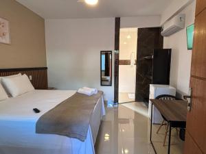 a hotel room with a bed and a desk at Pousada Estalagem Da Serra in Serra do Cipo
