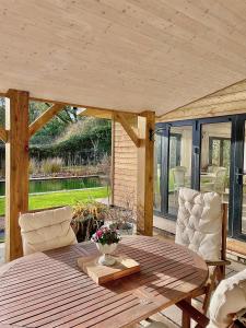 a wooden table and chairs on a patio at Garden House Barmeath Castle in Grangebellew