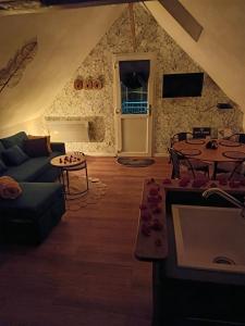a living room with a couch and a table at NATURAL COSY in Honfleur