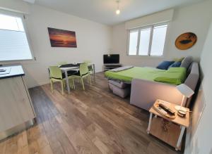 a bedroom with a bed and a table and chairs at Myhouse Apartment in Cervignano del Friuli +21 photos