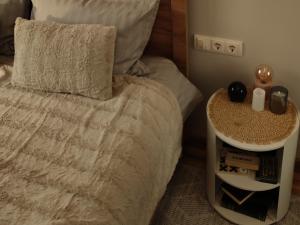 a bedroom with a bed and a nightstand next to it at ILLU Resort in Orhei