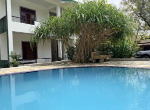 a large blue swimming pool in front of a house at Royal Garden in Dambulla