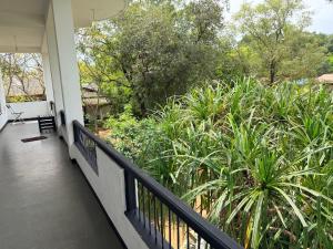 a balcony of a house with trees and plants at Royal Garden in Dambulla