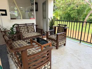 a group of chairs sitting on a porch at Royal Garden in Dambulla +24 photos