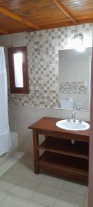 a bathroom with a sink and a mirror at Casa 7 personas in Villa Gesell +3 photos