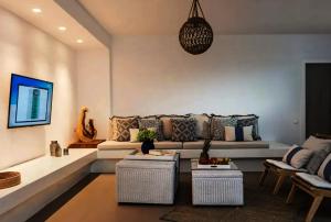 a living room with a couch and a table and chairs at Ios sea view in Ios Chora