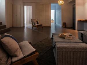 a living room with a couch and a chair at Ios sea view in Ios Chora