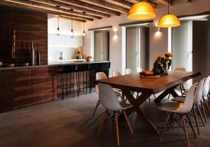 a kitchen and dining room with a wooden table and chairs at Ios sea view in Ios Chora