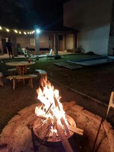 a fire pit in a yard at night at La posadita sp in San Pedro