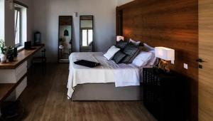 a bedroom with a large bed with white sheets and pillows at Ios sea view in Ios Chora