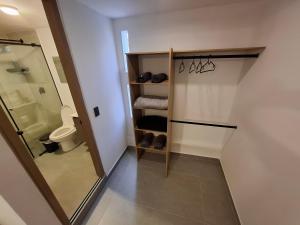 a bathroom with a walk in shower and a toilet at Hotel La Casona - Cerca al Estadio Atanasio Girardot y Laureles in Medellín