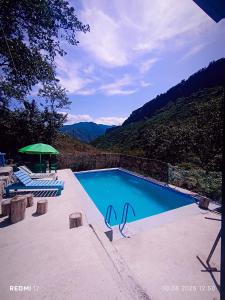 a swimming pool with a view of a mountain at Camping Three poplars by VL in Alaverdi