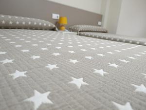 a bed with white stars on a bedsheet at VUT Montse in Alcañiz