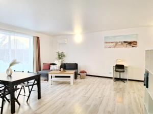 a living room with a couch and a table at Kopų tako apartamentai in Melnragė