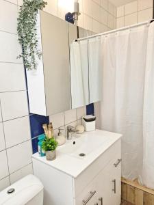 a bathroom with a white sink and a mirror at Kopų tako apartamentai in Melnragė +20 photos