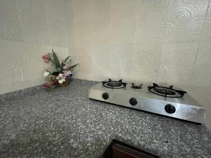 a stove top oven sitting on a counter with flowers at Jerash Skyline in Jerash +6 photos