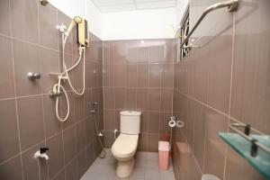 a bathroom with a toilet and a shower at Yala Elegant Hotel in Tissamaharama +29 photos
