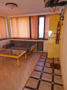 a living room with a couch and a table at Бар-Пляж in Bassalychevka