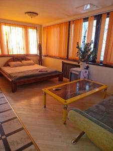 a living room with two beds and a coffee table at Бар-Пляж in Bassalychevka