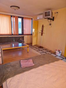 a living room with a couch and a table at Бар-Пляж in Bassalychevka