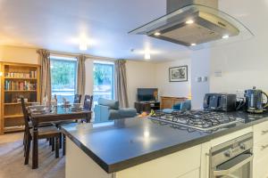 a kitchen and living room with a stove top at Torr Apartment Raven in Fort Augustus