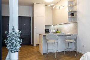 a kitchen with a christmas tree next to a counter at Apollo One, 1BR Signature Residence in Nivy +22 photos