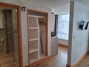 a room with a closet with a glass door at The Albert Hotel in Gloucester