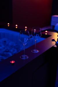 two wine glasses sitting on top of a bar at Luxury Love Suites in Elbasan