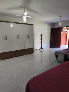 a large room with white cabinets and a tree in it at Casa Bilbao in Maricá
