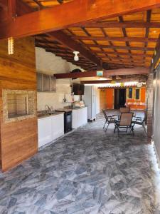 a large kitchen with a table and chairs in it at Casa Bilbao in Maricá